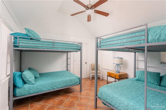 bedroom with ceiling fan, a closet, crown molding, and lofted ceiling