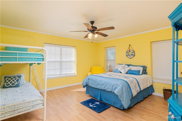 bedroom featuring ceiling fan, hardwood / wood-style floors, and ornamental molding