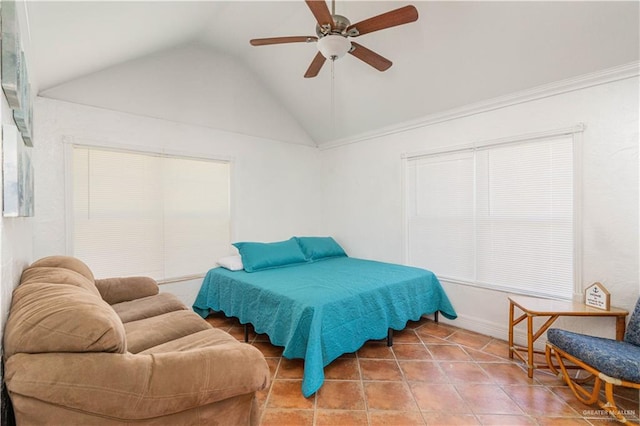 tiled bedroom with ceiling fan and vaulted ceiling