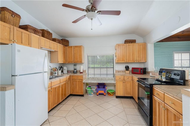 kitchen featuring a wealth of natural light, white refrigerator, vaulted ceiling, and black / electric stove