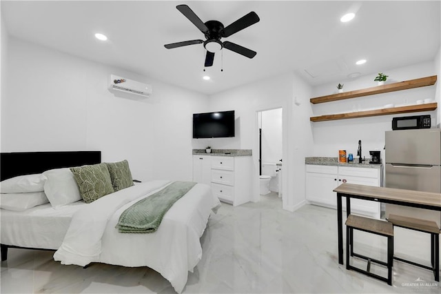 bedroom with a wall mounted air conditioner, stainless steel fridge, ensuite bathroom, and ceiling fan