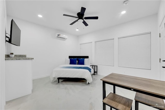 bedroom featuring a wall unit AC and ceiling fan