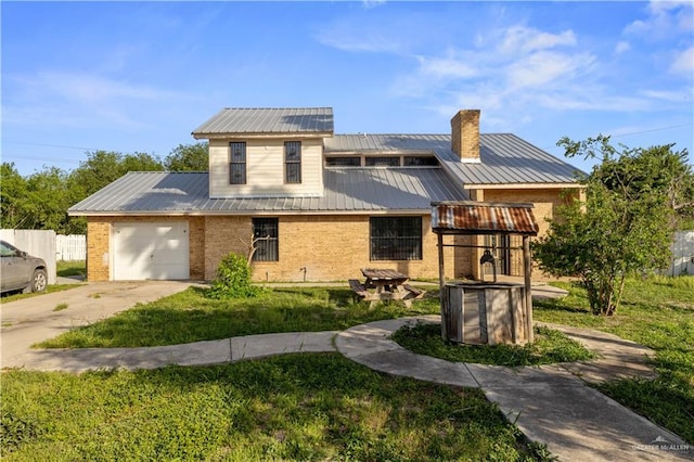3401 Del Norte Dr, Mission, TX 78574 - view of front facade featuring a chimney, metal roof, brick siding, and concrete driveway