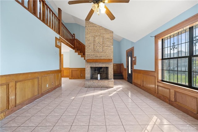 3401 Del Norte Dr, Mission, TX 78574 - unfurnished living room with a wainscoted wall, high vaulted ceiling, a ceiling fan, and a decorative wall