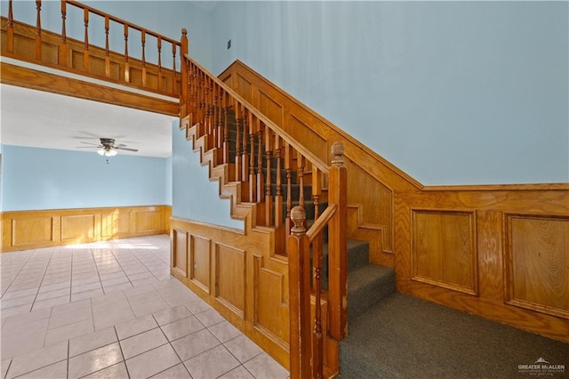 3401 Del Norte Dr, Mission, TX 78574 - staircase with ceiling fan, a decorative wall, a wainscoted wall, and tile patterned floors