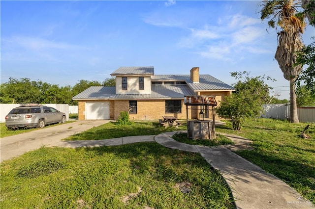 3401 Del Norte Dr, Mission, TX 78574 - view of front of property featuring a chimney, fence, driveway, brick siding, and metal roof