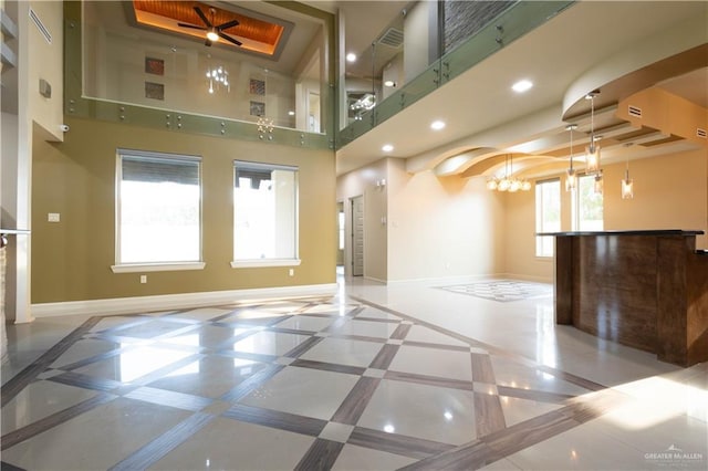 2410 W Vancouver Ave, Edinburg, TX 78539 - spare room with inlaid floor details, baseboards, a towering ceiling, a tray ceiling, and recessed lighting