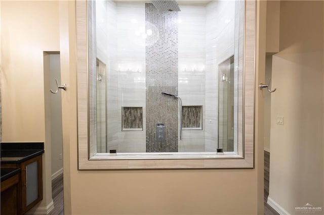 2410 W Vancouver Ave, Edinburg, TX 78539 - bathroom featuring tiled shower, baseboards, and vanity