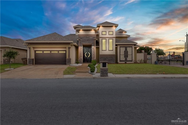 2410 W Vancouver Ave, Edinburg, TX 78539 - view of front facade with stone siding, stucco siding, a garage, driveway, and a gate
