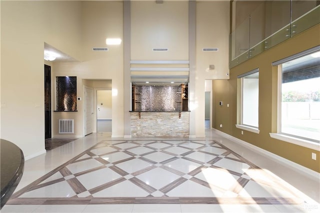 2410 W Vancouver Ave, Edinburg, TX 78539 - unfurnished living room featuring a high ceiling, baseboards, and inlaid floor details