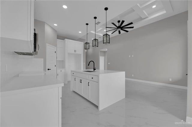 kitchen featuring recessed lighting, coffered ceiling, a sink, a ceiling fan, and marble finish floor