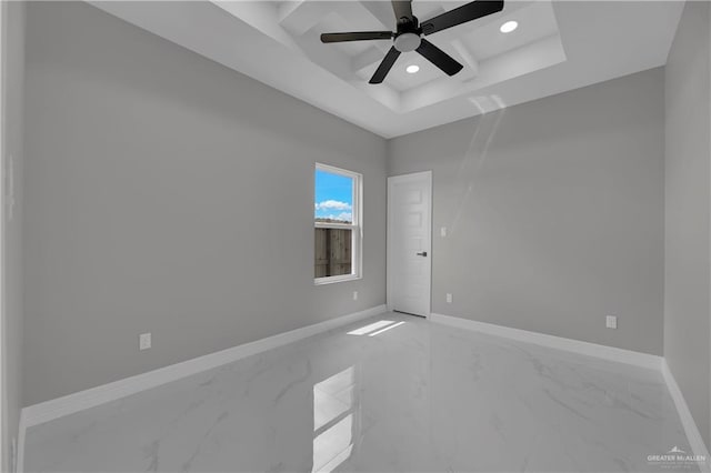 empty room featuring baseboards, a ceiling fan, marble finish floor, a tray ceiling, and recessed lighting