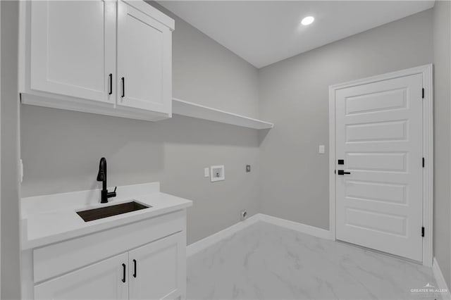 laundry room with washer hookup, marble finish floor, cabinet space, a sink, and baseboards