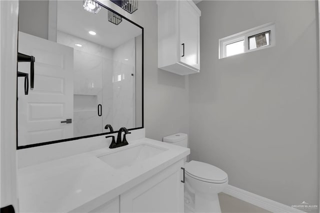 bathroom featuring vanity, a marble finish shower, toilet, and baseboards