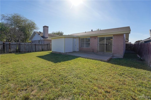 back of house featuring a yard and a patio