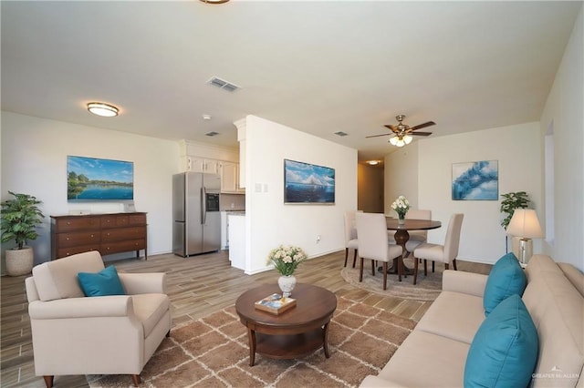 living room featuring hardwood / wood-style floors and ceiling fan