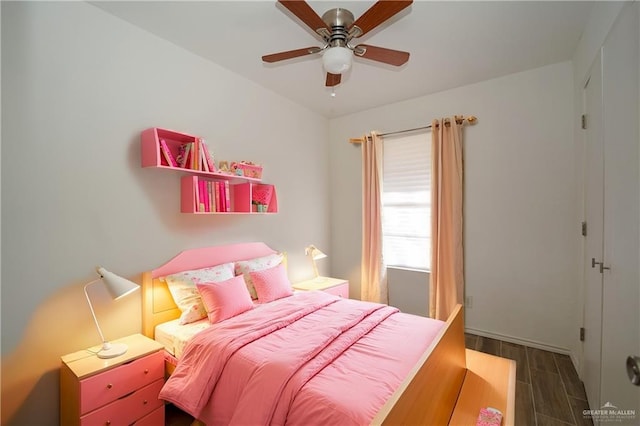 bedroom with ceiling fan and dark hardwood / wood-style flooring