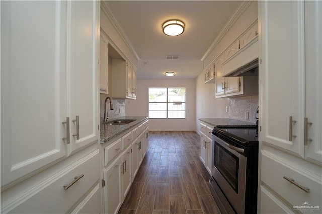 kitchen with light stone counters, sink, dark hardwood / wood-style floors, white cabinetry, and stainless steel electric range