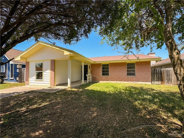 rear view of property featuring a lawn