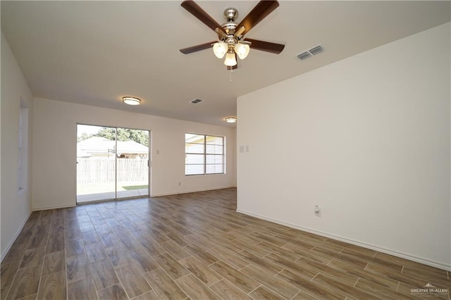 empty room with hardwood / wood-style flooring and ceiling fan