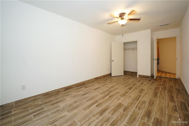 unfurnished bedroom with a closet, hardwood / wood-style flooring, and ceiling fan