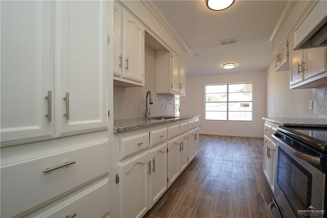 kitchen with white cabinetry, sink, dark wood-type flooring, and stainless steel range oven