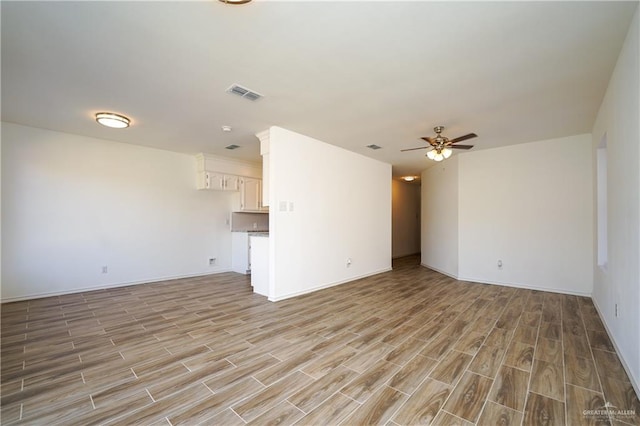 unfurnished living room featuring light hardwood / wood-style flooring and ceiling fan