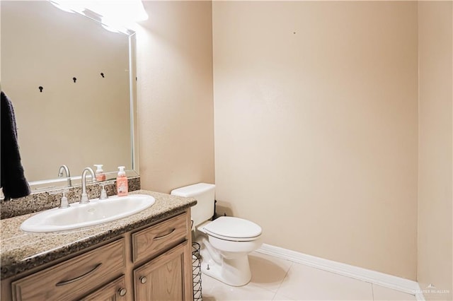 bathroom featuring tile patterned floors, vanity, and toilet