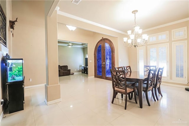 tiled dining area with ceiling fan with notable chandelier, ornamental molding, and french doors