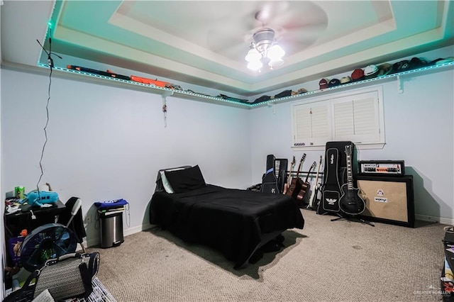 bedroom featuring carpet flooring, ceiling fan, and a raised ceiling