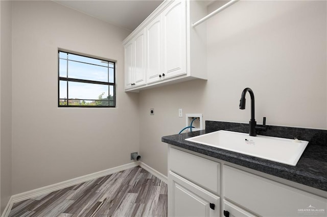 laundry area with cabinets, washer hookup, electric dryer hookup, sink, and light hardwood / wood-style floors