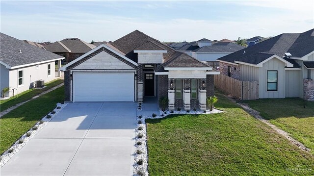 8801 Swan Lake Dr, Harlingen, TX 78550 - view of front of house with concrete driveway, central AC unit, a front yard, fence, and a garage