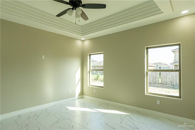 8801 Swan Lake Dr, Harlingen, TX 78550 - spare room with ceiling fan, recessed lighting, baseboards, marble finish floor, and a tray ceiling