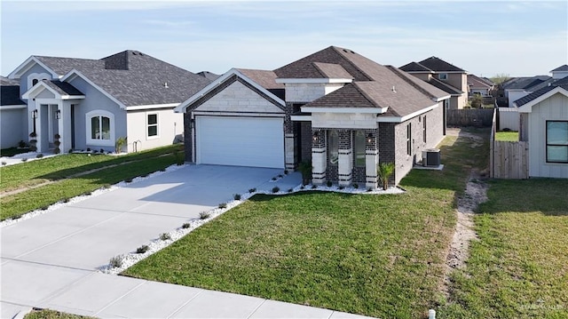 8801 Swan Lake Dr, Harlingen, TX 78550 - view of front facade featuring concrete driveway, central AC, a front lawn, and stone siding