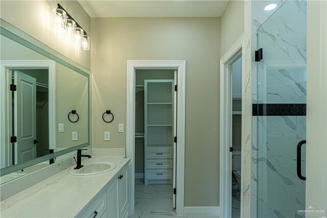 8801 Swan Lake Dr, Harlingen, TX 78550 - full bathroom with marble finish floor, vanity, toilet, and a spacious closet