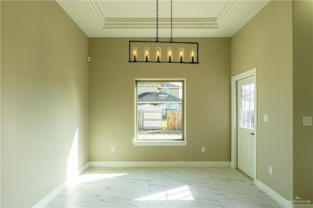 8801 Swan Lake Dr, Harlingen, TX 78550 - unfurnished dining area featuring marble finish floor, baseboards, and a raised ceiling