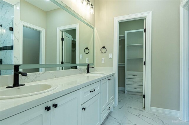 8801 Swan Lake Dr, Harlingen, TX 78550 - bathroom with marble finish floor, a sink, a marble finish shower, and a walk in closet