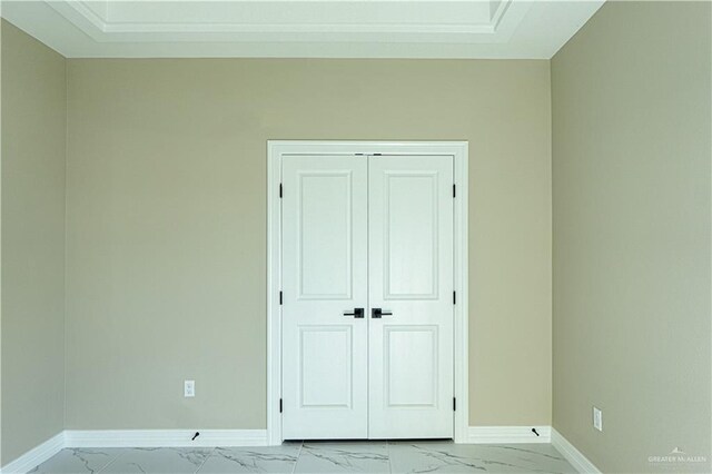 8801 Swan Lake Dr, Harlingen, TX 78550 - unfurnished bedroom featuring a closet, marble finish floor, and baseboards