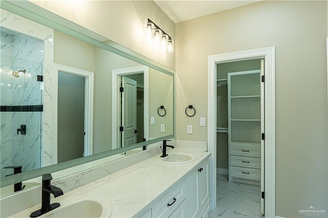 8801 Swan Lake Dr, Harlingen, TX 78550 - full bathroom featuring marble finish floor, a sink, a spacious closet, and a marble finish shower