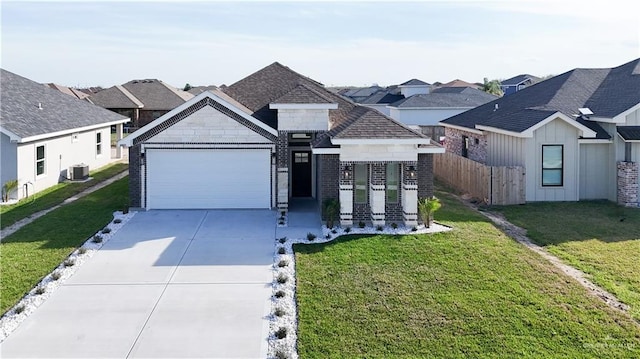 8801 Swan Lake Dr, Harlingen, TX 78550 - view of front of property featuring a garage, concrete driveway, fence, and a front lawn