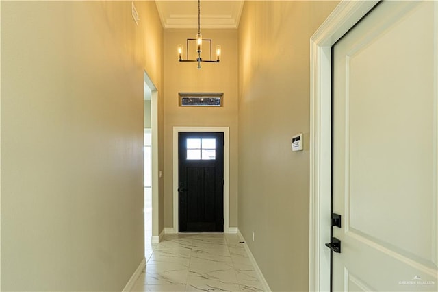 8801 Swan Lake Dr, Harlingen, TX 78550 - doorway to outside with a chandelier, marble finish floor, ornamental molding, and baseboards