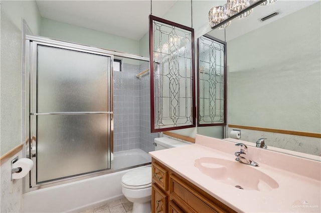 full bathroom with tile patterned floors, vanity, toilet, and combined bath / shower with glass door