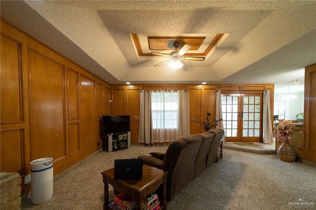 6913 N 31st St, Mcallen, TX 78504 - living room with carpet flooring, a ceiling fan, a raised ceiling, and a textured ceiling