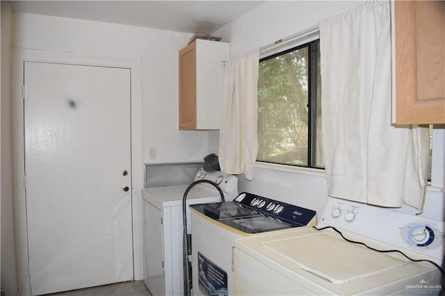 laundry area featuring cabinets and separate washer and dryer