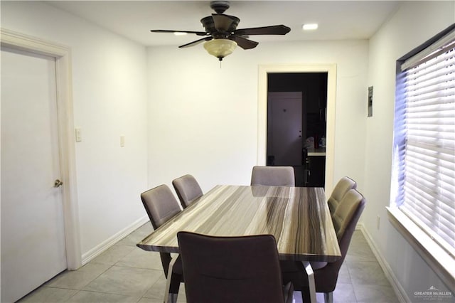 tiled dining room featuring ceiling fan