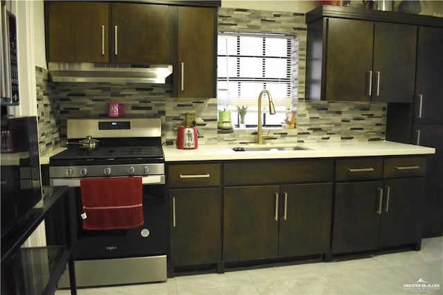 kitchen featuring backsplash, sink, dark brown cabinets, and stainless steel gas range