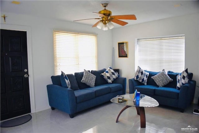 tiled living room featuring ceiling fan and a wealth of natural light