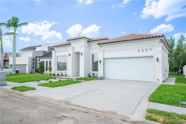 2607 Cottonwood St, Mission, TX 78574 - mediterranean / spanish-style house featuring a tile roof, a garage, driveway, stucco siding, and a front lawn