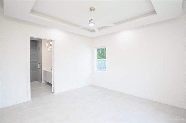 2607 Cottonwood St, Mission, TX 78574 - spare room with a tray ceiling, ceiling fan, and baseboards