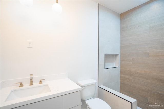 2607 Cottonwood St, Mission, TX 78574 - bathroom with vanity, toilet, and tiled shower
